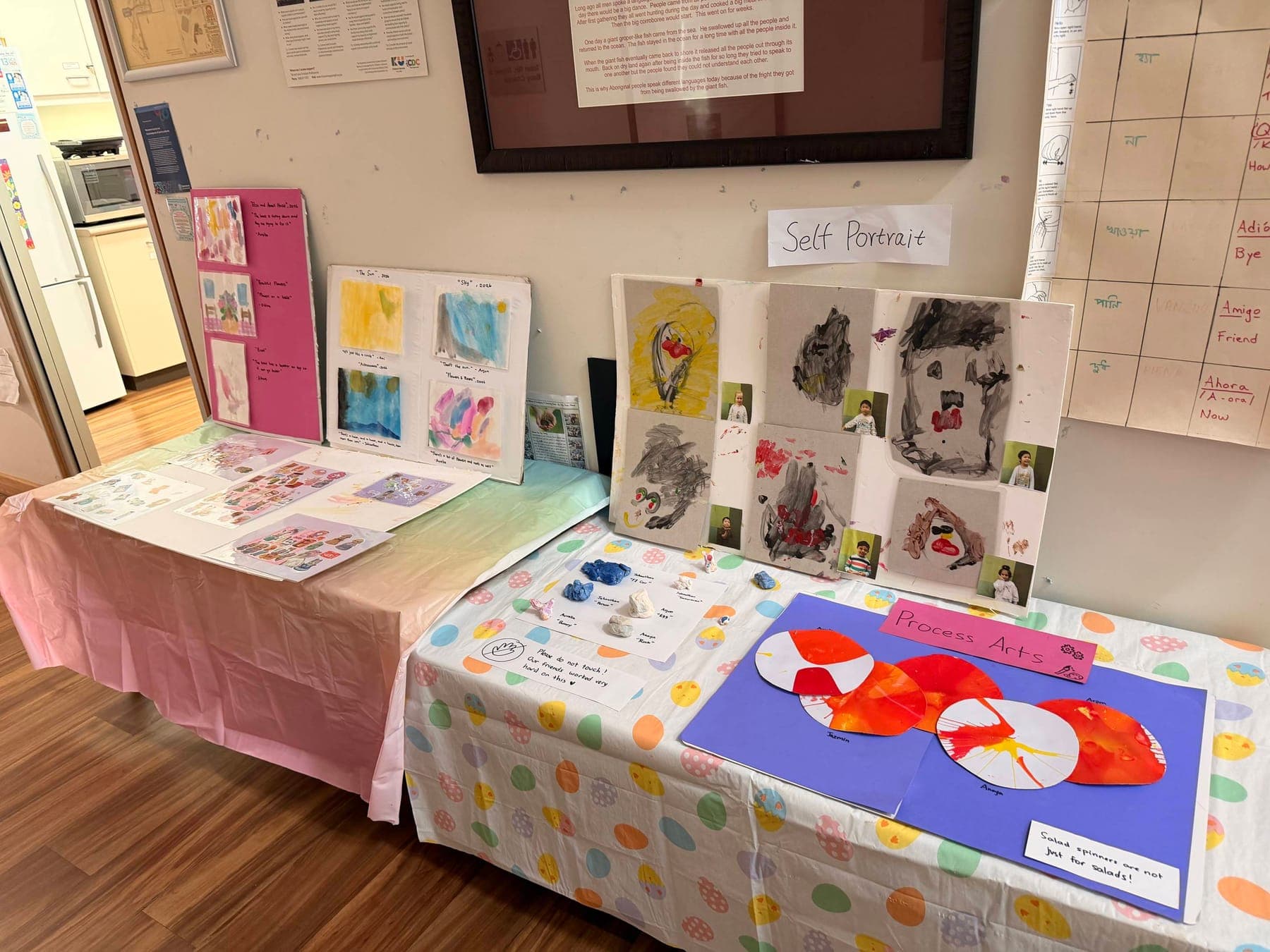 Children's self-portraits and process art on display in the centre foyer